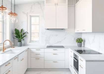 Modern U-shaped kitchen featuring white cabinets and marble countertops, complemented by potted plants, showcasing stylish living and kitchen design.